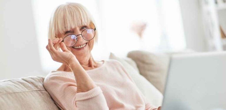 older lady wearing glasses smiling